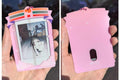 Pink photo frame with a small picture inside, held in a hand.