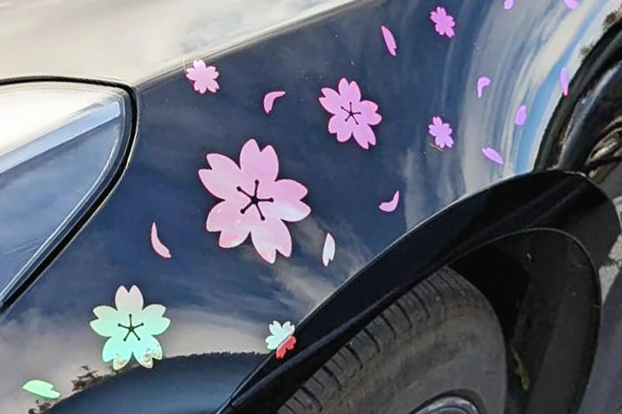 Car with colorful flower decals on a black surface